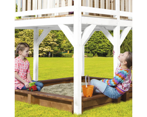 Speeltoren met zandbak en spelende kinderen in de tuin.