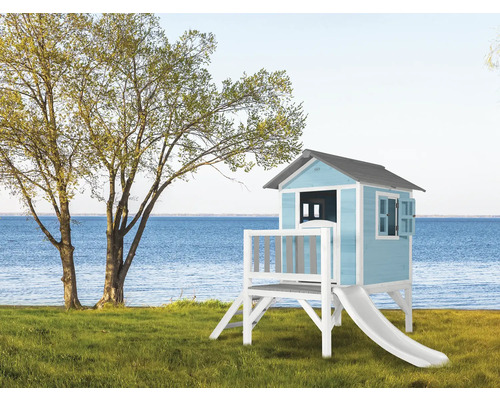 Houten speelhuis met glijbaan in de tuin