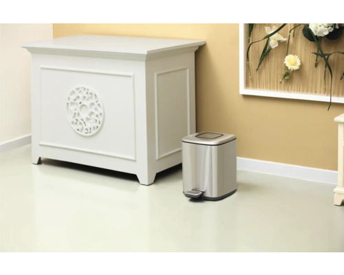 Scene met dressoir en zilverkleurige afvalemmer met pedaal