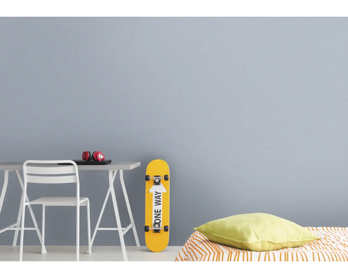 Jongenskamer met bureau, stoel, hoofdtelefoon, laptop, skateboard en kussen.