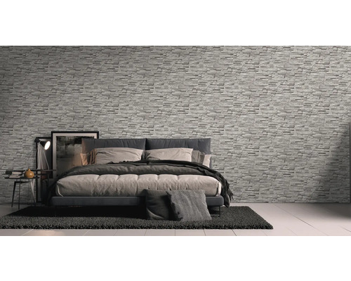 Slaapkamer met behang in steenlook, bed en nachtkastje