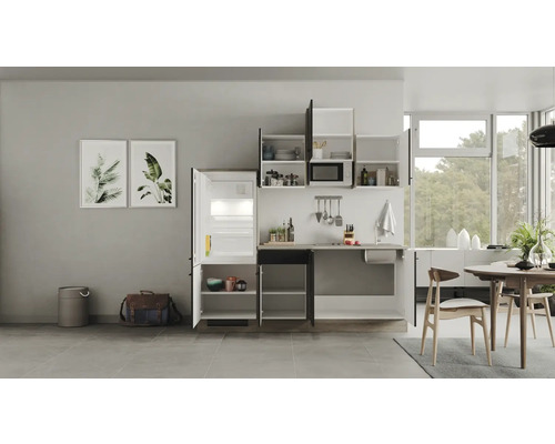 Lichte keuken met keukenblok, koelkast, hangkasten en eettafel