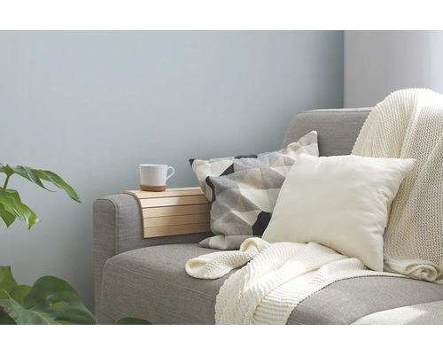 Grijze bank met kussens, deken en dienblad