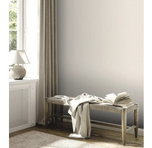 Lichte kamer met houten bank, boek en textiel
