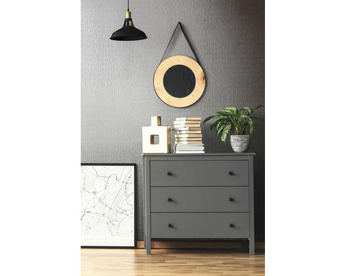 Grijze ladekast met drie laden, lamp, spiegel, decoraties en planten in een kamer