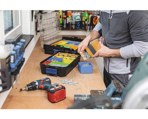 Werkbank met assortimentsdozen, schroeven en accuschroevendraaier