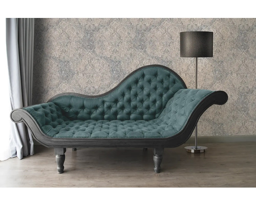 Chaise longue met knoophechting, staande lamp en behang met patroon