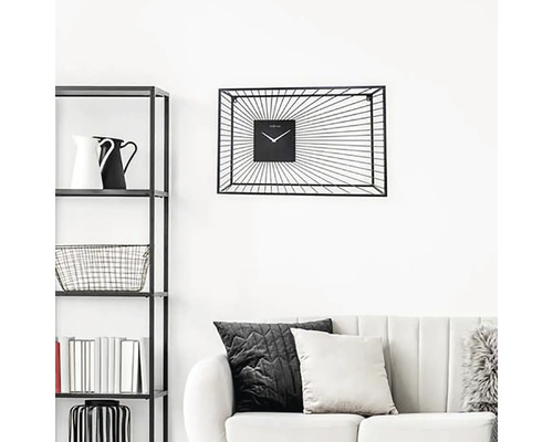 Woonkamer met rek, bank en zwarte wandklok