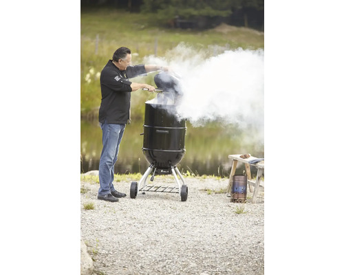 Man gebruikt een houtskoolgrill buiten.