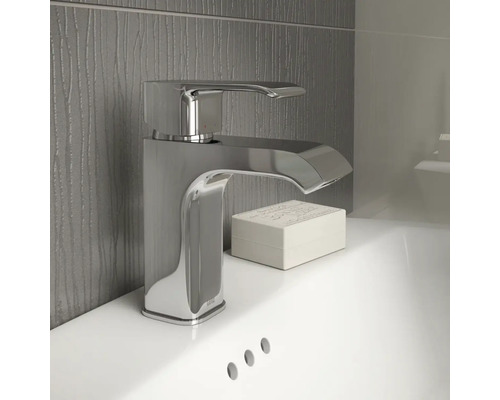 Glanzende wastafelmengkraan van metaal op een wastafel