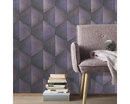 Kamerzicht met grafisch behang, fauteuil en stapel boeken.