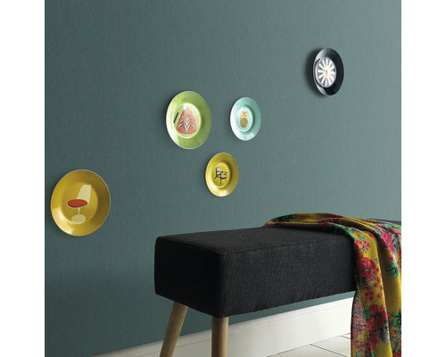 Wanddecoratie met sierborden en een bank