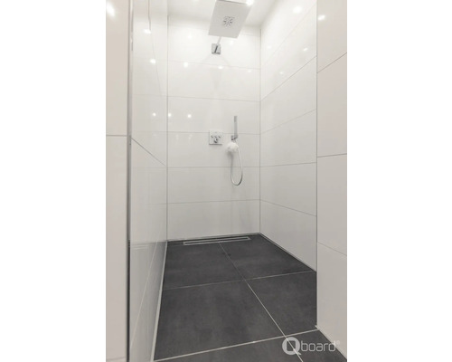 Inloopdouche met stortdouche en handdouche, betegeld met witte wandtegels en donkere vloertegels.