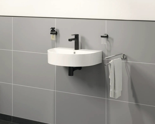 Moderne badkamer met waskom, kraan, zeepdispenser en handdoekhouder aan de muur.