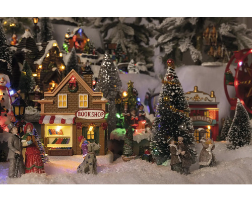 Kerstdorp tafereel met boekhandel, theater, figuren en bomen