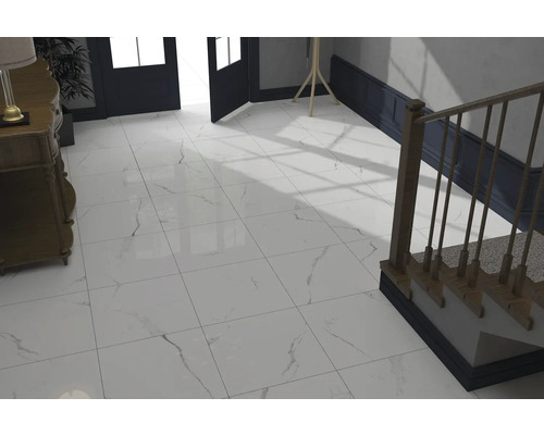 Lichte entree met vloertegels in marmerlook, trap en commode