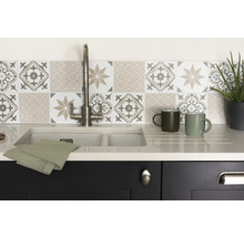 Keukenspoelbak met kraan, theedoek, mokken en decoratieve tegels