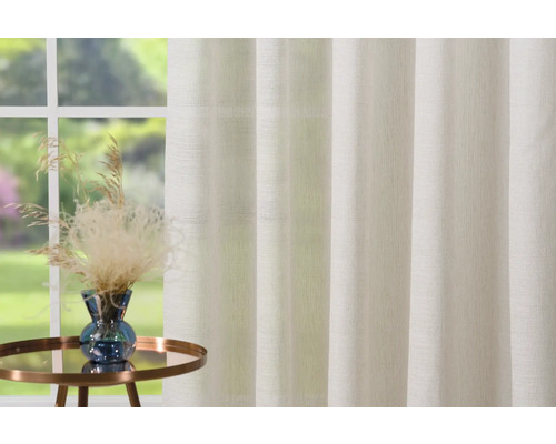 Decoratief gordijn voor het raam met plantenarrangement op een klein tafeltje