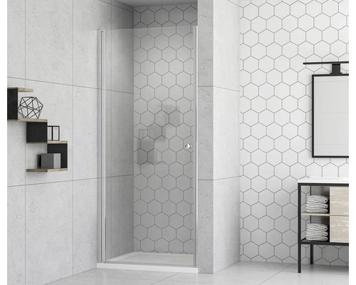 Badkamer met glazen douchecabine en witte zeshoekige tegels.