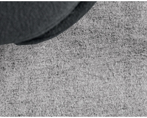 Detailopname van een tapijt met een deel van een zitting.