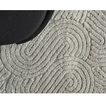 Detailopname van een vloerkleed met grafisch patroon