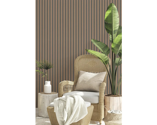 Scene met lamellenwand, rotan stoel, kussen, deken en plantenpotten