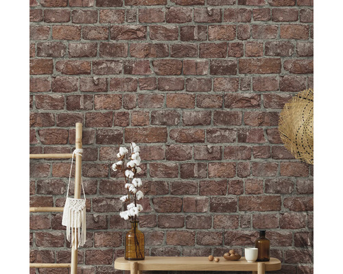 Muur met bakstenen behang en decoratieve elementen zoals een ladder, tas, hoed, vaas en tafel