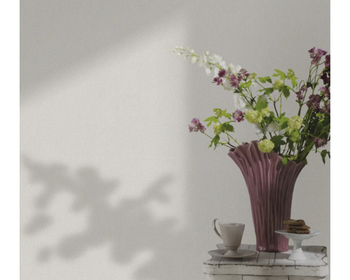Stilleven met bloemen, vaas, kopje en gebak op een tafel