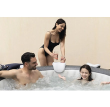 Familie ontspant in een opblaasbare jacuzzi met bekerhouder.