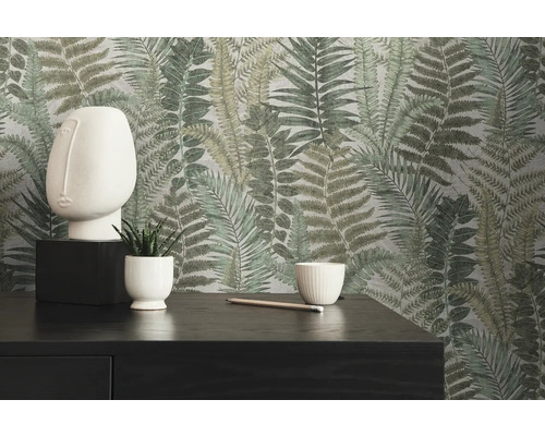 Decoratief interieur met behang met varenpatroon, sculptuur, planten en donkere commode