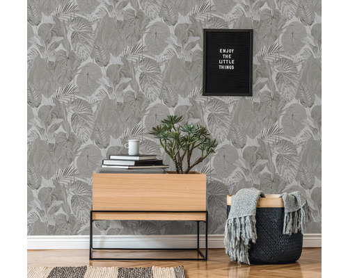 Woonkamer met botanisch patroonbehang, plantentafel en decoraties voor een natuurlijke sfeer