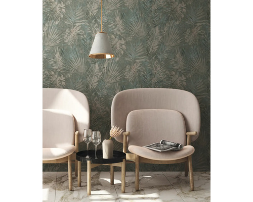 Woonkamer met behang met bladerpatroon, twee fauteuils en een bijzettafel met decoratie