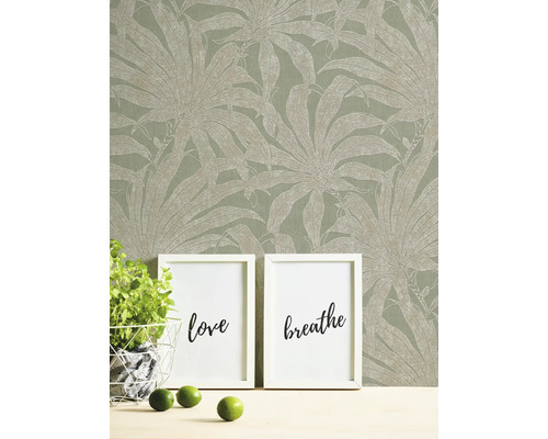Decoratief behang met plantenmotief, aangevuld met fotolijsten en decoratie