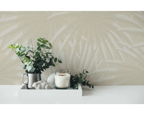 Decoratieve scène met behang met bladmotief, eucalyptus takken in een kan, een kaars en een konijnenbeeldje