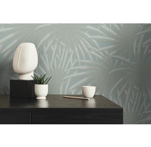 Scene met decoratief behang, decoratief figuur, plant en potlood op een commode