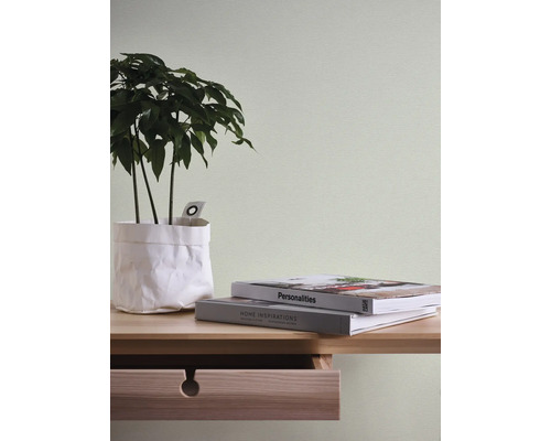 Close-up van een tafel met plant, boeken en lade
