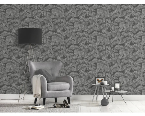 Woonkamer met grijs bladbehang, fauteuil en staande lamp