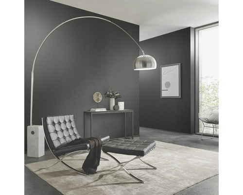 Woonkamer met booglamp, fauteuil en hocker