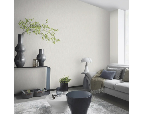 Woonkamer met gestructureerd behang, bank en decoratieve elementen voor een stijlvol interieur