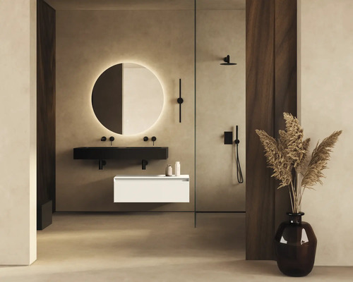 Badkamer met ronde spiegelverlichting, zwarte wastafel, witte onderkast en douche.