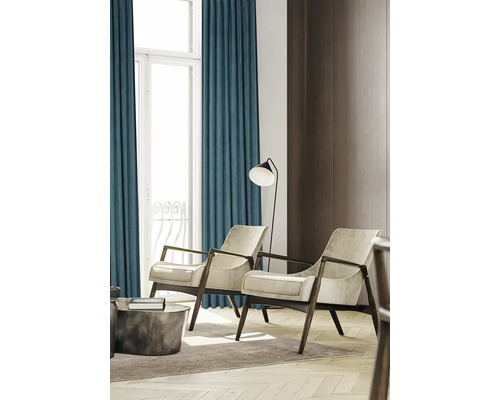 Woonkamer met gordijnen, twee fauteuils en een staande lamp