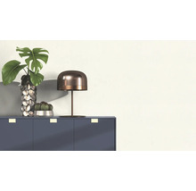 Decoratieve opstelling met tafel, lamp, vaas en planten op een kast.