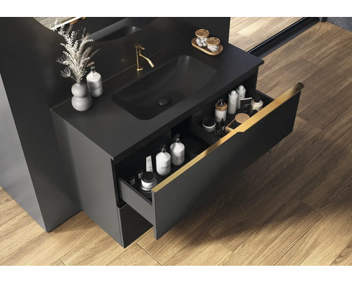 Zwarte wastafelonderkast met open lade in badkamer