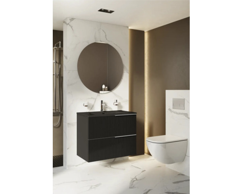 Badkamer met zwarte wastafelonderkast, ronde spiegel en wandhangend toilet.