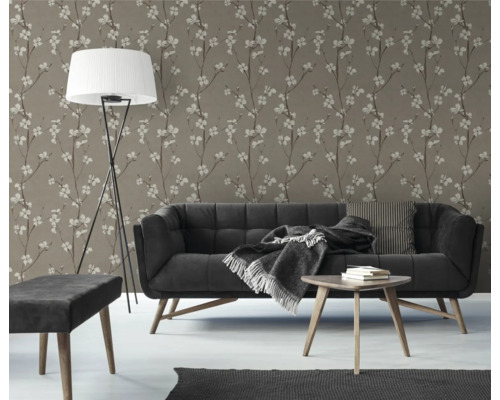 Woonkamer met bloemig behang, bank en staande lamp