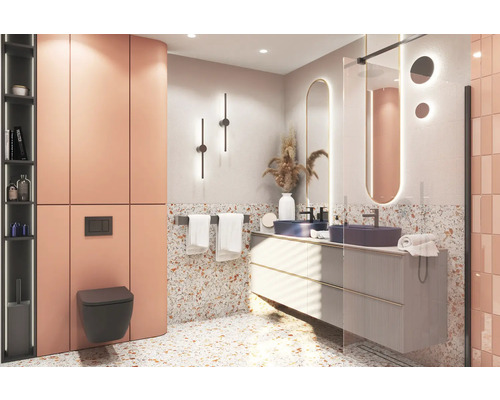 Moderne badkamer met wastafel, spiegel, toilet en tegels in terrazzo-look.