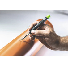 Een hand markeert een bruine buis met een Pica Dry Longlife Automatic Pencil.