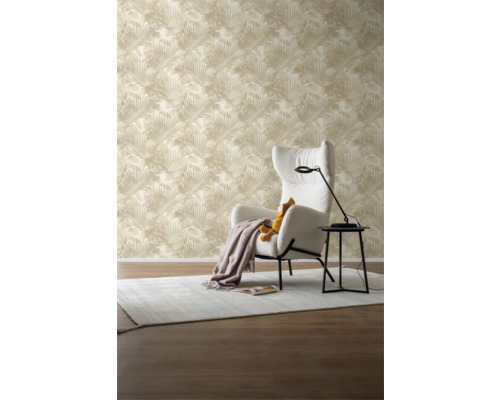 Woonkamer met beige behang met palmmotief, fauteuil en bijzettafel.