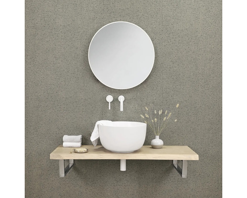 Moderne badkamer met ronde spiegel, wastafel en kranen