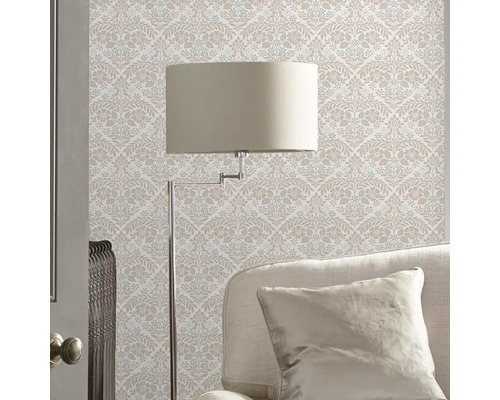 Kamerimpressie met patroonbehang, staande lamp en bank